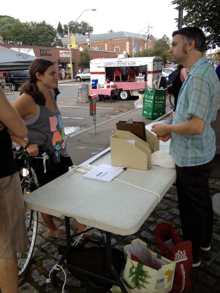 Talking about community at a street fair. (Photo by Jacy Edelman)