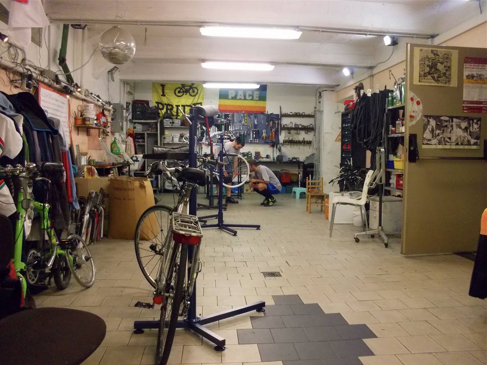 Mechanics work on a bicycle in Ciclofficina Centrale