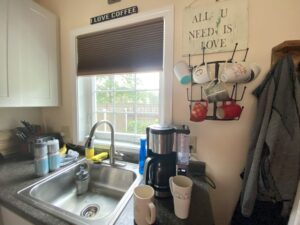 photo of tiny house kitchen sink and wall mounted coffee mug rack