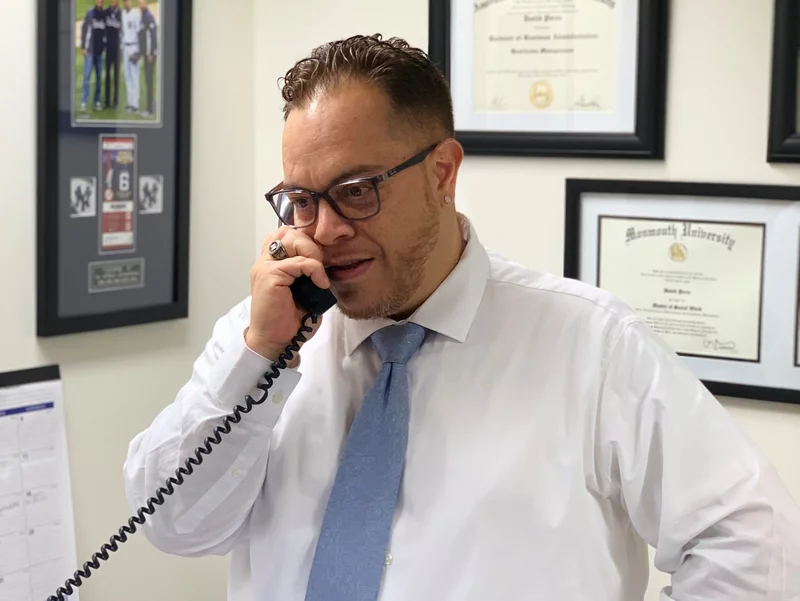 Photo of a man in business attire making a phone call