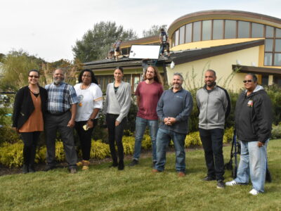 energy; Members of the Shinnecock Indian Nation stand alongside representatives from the SUNation and the Long Island Progressive Coalition, celebrating the installation of solar panels on the Wuneechanunk Shinnecock Preschool. Credit: Stephen J. Kotz