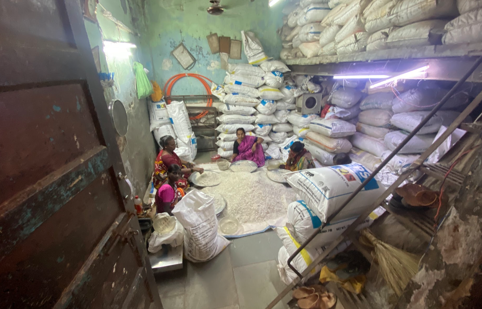 The recycling of waste materials is a principal industry in the Dhavari slum. Here, women are seen sorting ground plastic, which will be used to make exportable pellets. Credit: Jeffrey Andreoni