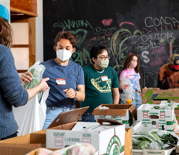 Market Box volunteers prep and box food for deliveries. Credit: Davon Clark