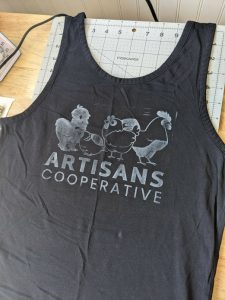 Artisans Cooperative fundraising tee, created by Lee Cattarin's Riverside Refuge Studio.