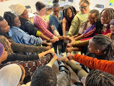 BlacSpace Cooperative: Hands in a circle of unity.