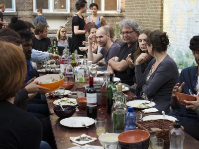 People gathering for a community dinner outside