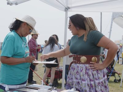 A native woman from North Dakota Native vote recruiting new electric cooperative members to join the energy task force at the Spriit Lake powWow